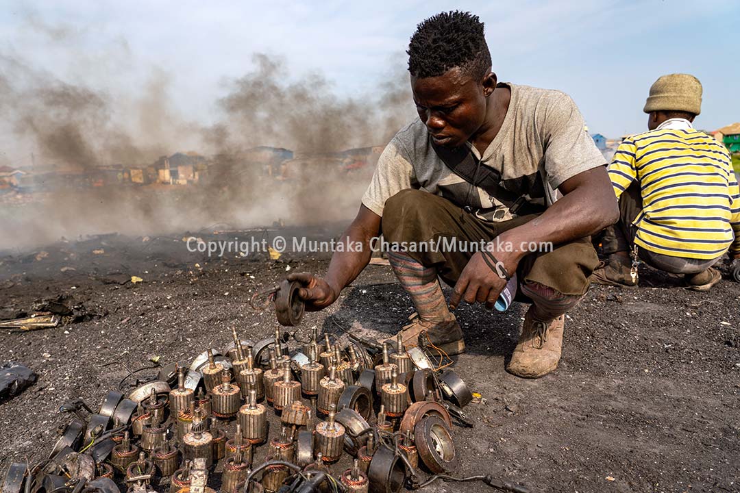 A worker is about to burn armature and other materials to recover copper. Copyright © Muntaka Chasant