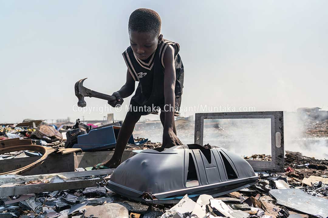 Kwadwo, 9, uses a hammer to break apart a cathode-ray tube-based TV for the iron materials inside at Agbogbloshie, Ghana. This exposed him to dangerous levels of lead. © 2020 Muntaka Chasant