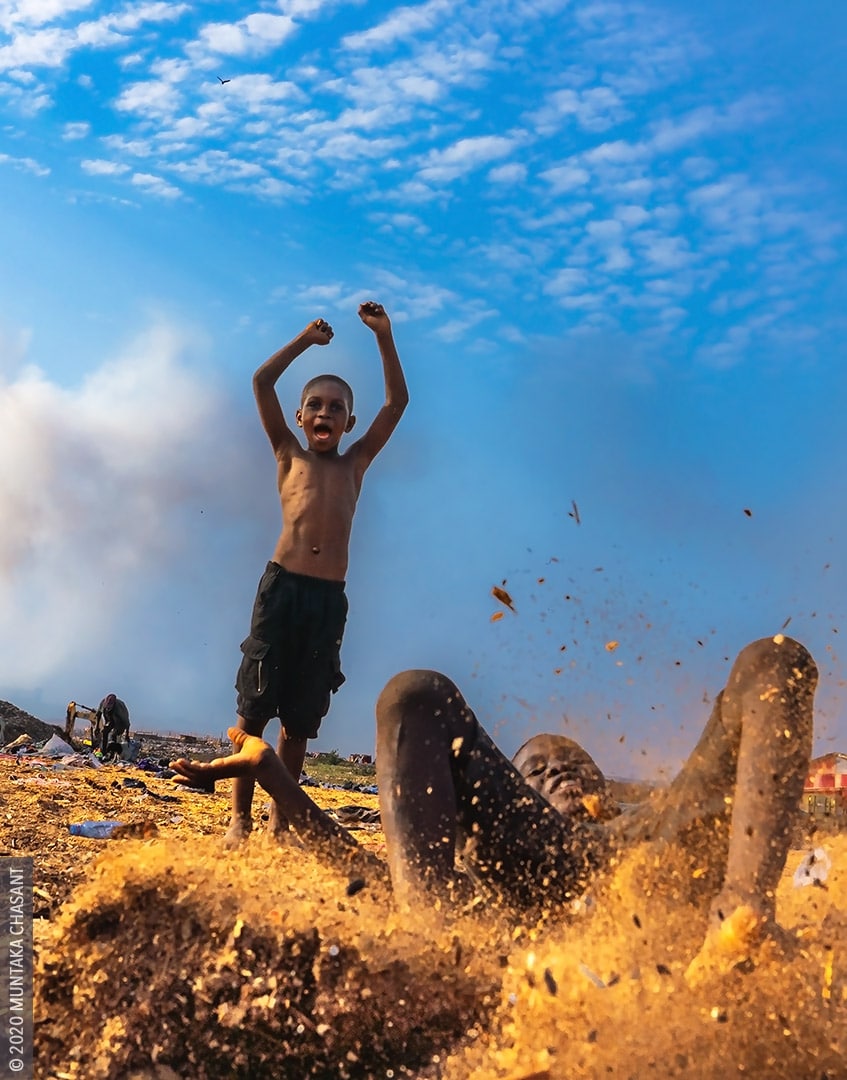 Agbogbloshie slum children having fun in sawdust. Captured at Agbogbloshie, Ghana. © 2020 Muntaka Chasant