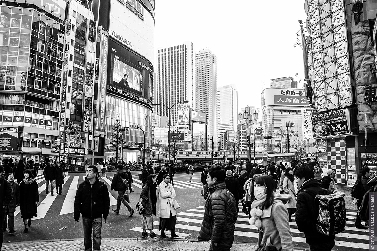 Shinjuku Street Photography: Pedestrians making their way across a big intersection in Shinjuku, Tokyo, Japan. Shinjuku is home to the Shinjuku Station, the world's busiest railway station. © 2016 Muntaka Chasant