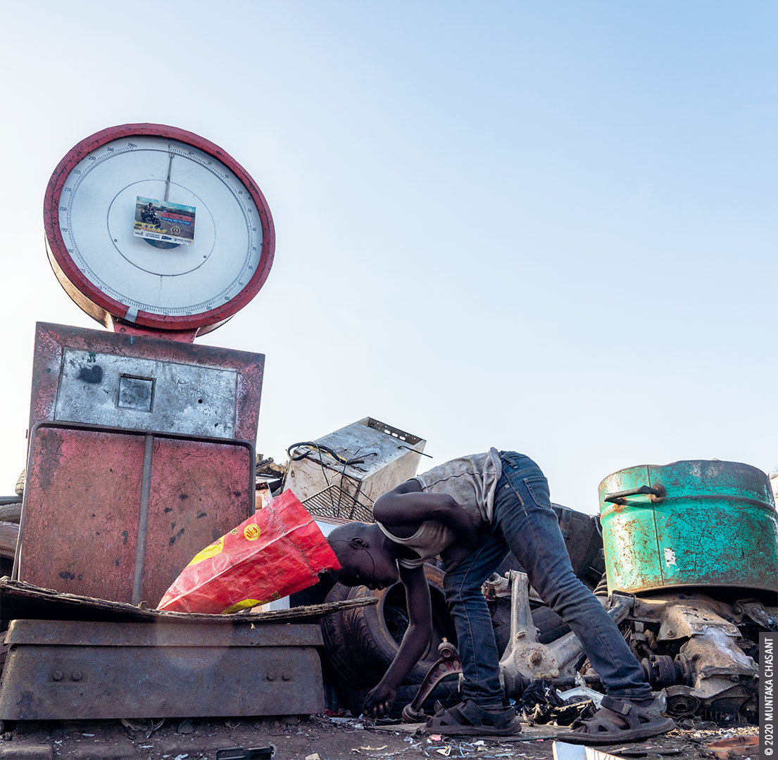 Agbogbloshie child labour: An 8 years old hazardous child labourer is scavenging for scrap metals in harsh conditions at Agbogbloshie, Ghana. According to the ILO, 1 in 5 children in Africa (compared to 1 in 25 in Europe & Central Asia) are in child labour.