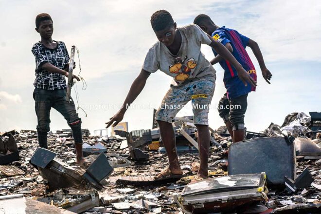 Child labour image: Kwaku Debrah, a 15 years old adolescent, has just smashed an old CRT TV against a rock to reclaim the iron materials inside at Agbogbloshie, Ghana. A piece of CRT glass stuck in his hair fell past his left eye, overshadowing it. Debrah is already blind in the left eye and wears a prosthetic. More than 60% of children in hazardous work worldwide are boys, according to ILO estimates. © 2020 Muntaka Chasant