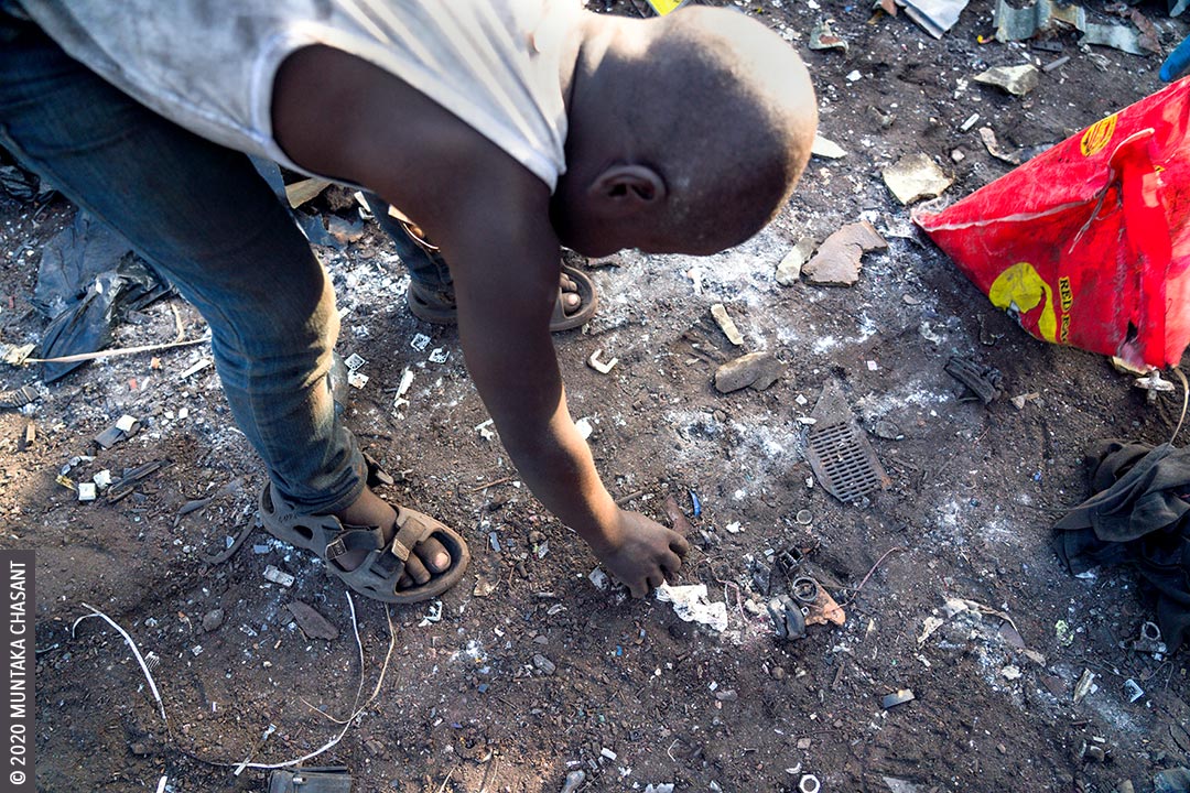 Hazardous child labour at Agbogbloshie: An 8-year-old boy engaged in hazardous child labour handpick pieces of metals deposited in the soil at Agbogbloshie, Ghana. He sold the metals at around GH₵0.80 ($0.15) per kilo at Agbogbloshie. This exposed him to lead, cadmium, arsenic, and other heavy metals. 19 million children below the age of 12 years are in hazardous child labour worldwide, according to the ILO. © 2020 Muntaka Chasant