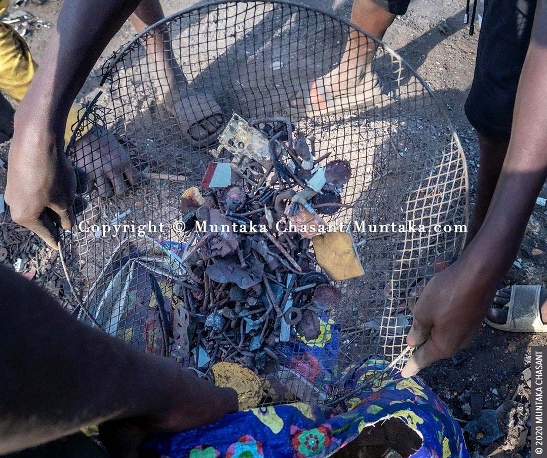 Child labour: Nails and other small metals are being processed before they are weighed and sold at Agbogbloshie, Ghana. © 2020 Muntaka Chasant