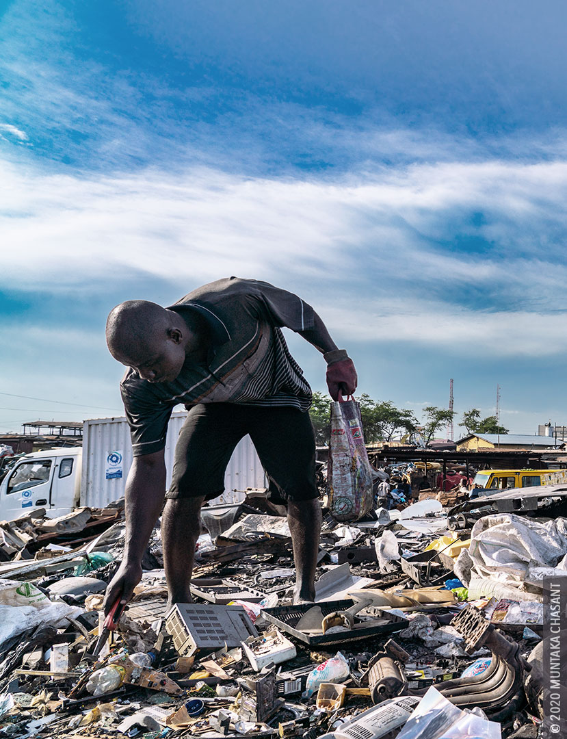 Urban Poverty: An urban poor man is using a plier to pick up a discarded part of a printed circuit board at Agbogbloshie, Ghana. Hundreds of young people living on the margins of Agbogbloshie cannibalize from e-waste as a livelihood strategy. Estimated figures show nearly 9 out of every 10 people in extreme poverty will be living in Africa by 2030. © 2020 Muntaka Chasant