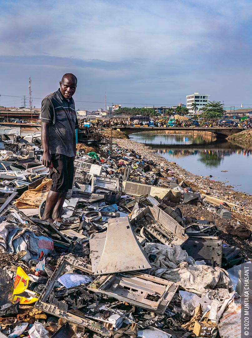 Urban Poverty in Africa: An urban poor Nigerian man is singing and cannibalizing from discarded e-waste at Agbogbloshie, Ghana. 41% of people in Africa live in extreme poverty, World Bank data shows. © 2020 Muntaka Chasant