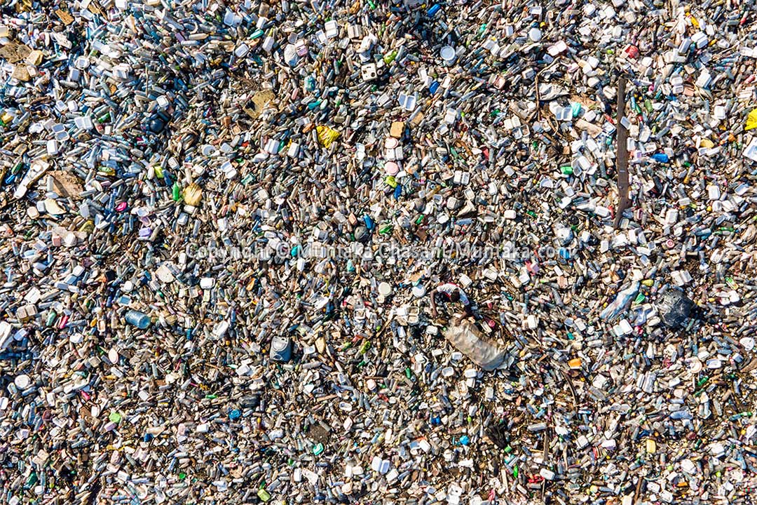 Kwabena is barely visible from a bird's eye perspective as he recovers recyclable plastics from the heavily polluted Korle Lagoon. The plastics sold for around $0.17 per kilo, but the coronavirus pandemic has crippled plastic recycling worldwide. Copyright © Muntaka Chasant 