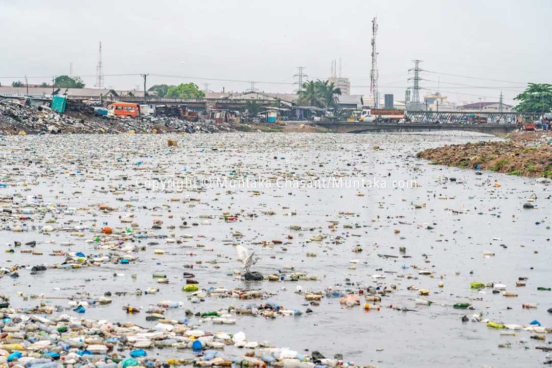 Plastic waste floats on the surface of the Korle Lagoon in Accra during a rainfall event. The majority of the plastics end up in the ocean.  Copyright © Muntaka Chasant