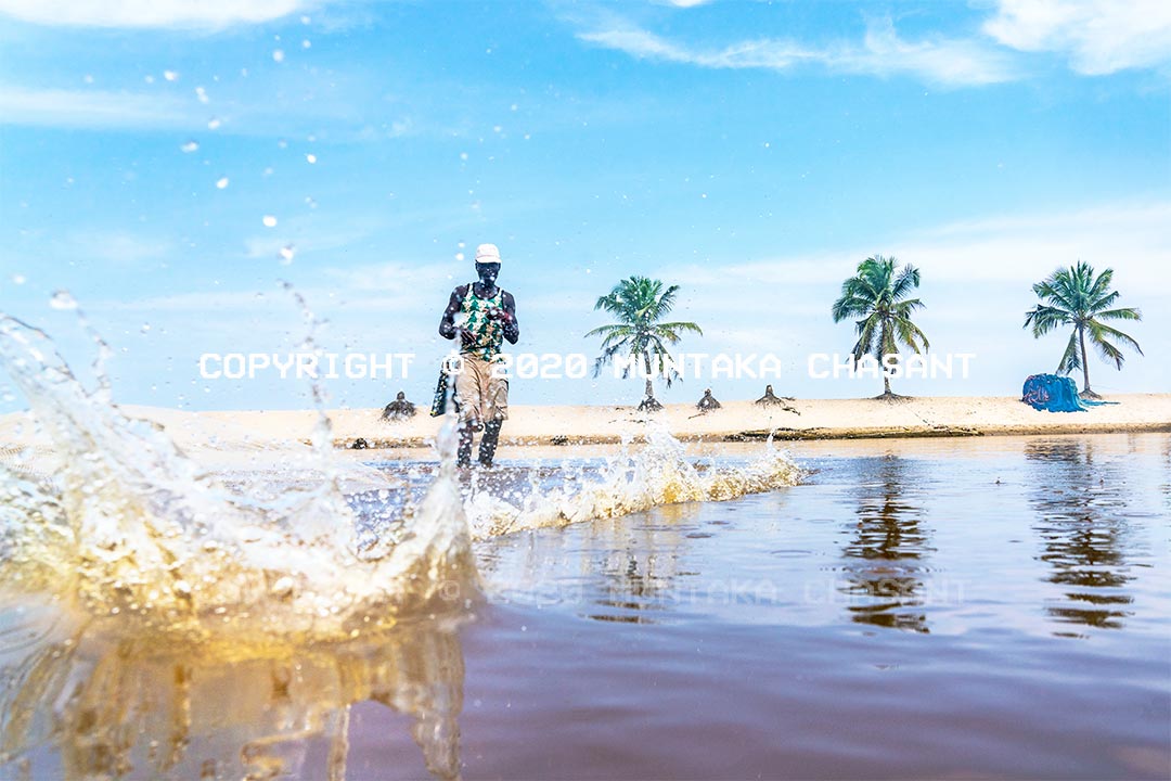 Fisheries and climate change: Fisherman in Ghana casts a net over a lagoon. Copyright © 2020 Muntaka Chasant