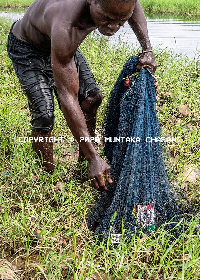Plastic pollution in Ghana: Poor fisherman fishes in a polluted environment due to catching plastic debris when he goes out to the sea. Copyright © 2020 Muntaka Chasant