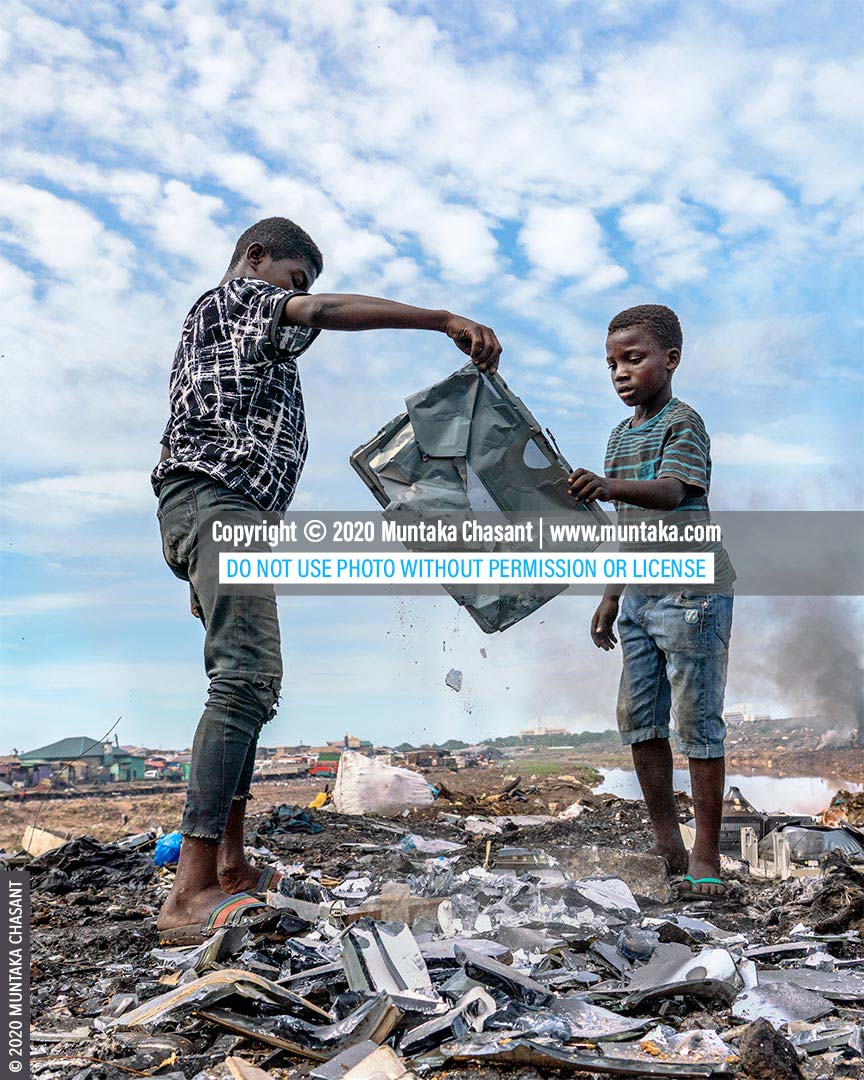 Child labour: Osei, 15 years old, had just helped Ibrahim, 11 years, to recover a shadow mask from an old CRT TV at Agbogbloshie, Ghana. Iron scrap sold for around $0.15 per kilo at Agbogbloshie in May 2020. © 2020 Muntaka Chasant