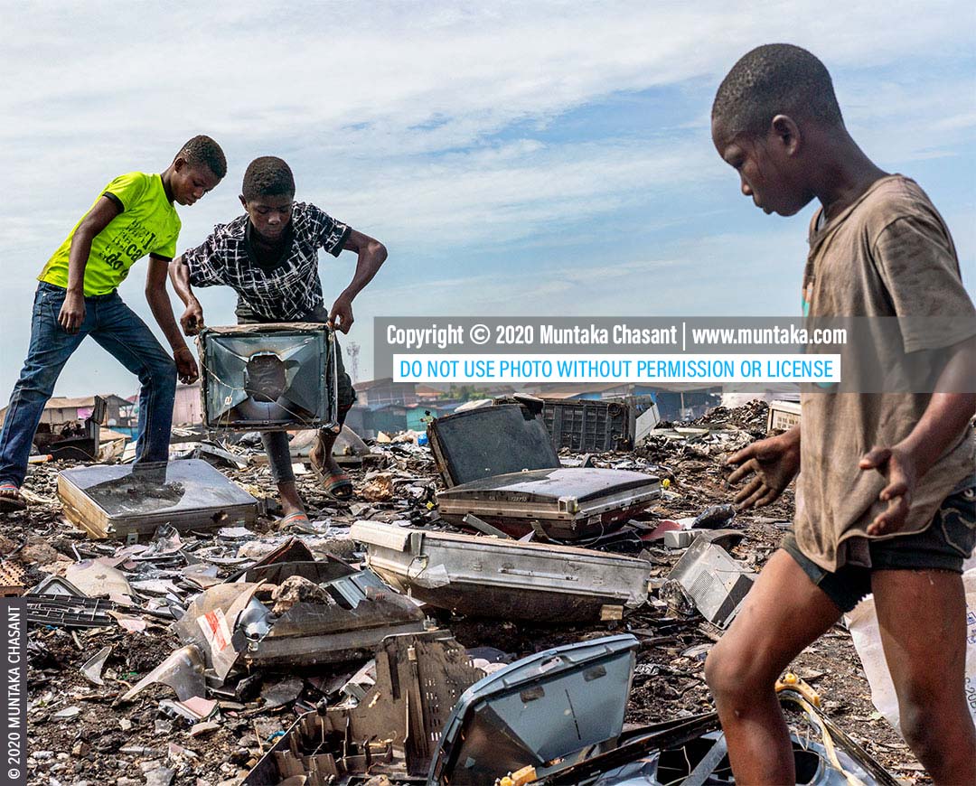 Hazardous child labour in Africa: Left to right: Ankrah, 14 years, Osei, 15 years, and Mustafa, 13 years, are dismantling old CRT TVs with their bare hands and stones to recover the iron metals inside. This exposed them to heavy metals such as lead and cadmium. Approximately 31.5 million children in Africa are in child labour, the ILO statistics show. © 2020 Muntaka Chasant