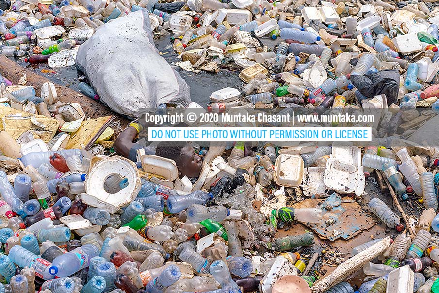 Plastic pollution: An urban poor man held on tightly to his collected plastics in a sack even as he nearly submerged in the polluted Korle Lagoon. Copyright © 2020 Muntaka Chasant
