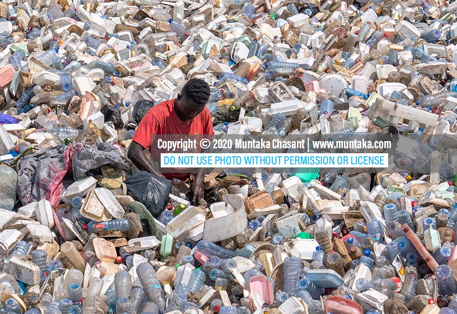 Plastic pollution in Ghana: Urban poor Ghanaian man swims in the polluted Korle Lagoon near the center of Accra to recover plastic waste to sell to recyclers. Ghana generates roughly around 1 million tons of plastic waste each year, a UND report shows. Copyright © 2020 Muntaka Chasant