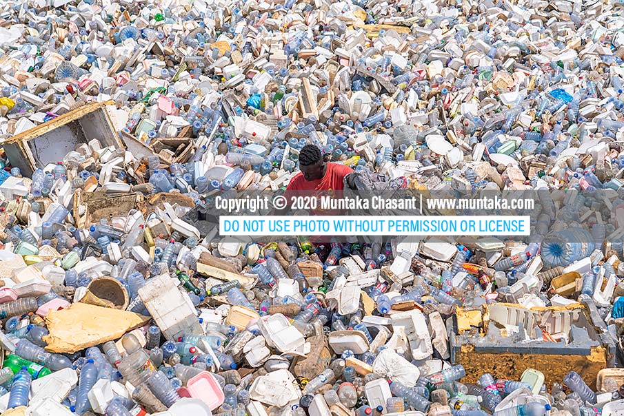 Plastic pollution picture: A 2020 photograph of an urban poor man recovering recyclable plastics in the Korle Lagoon, Accra, Ghana. Copyright © 2020 Muntaka Chasant