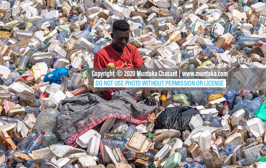 Plastic pollution photo: Urban poor man recovers recyclable plastics from the polluted Korle Lagoon in Accra, Ghana's capital city. Only around 9% of the 8.3 billion tons of plastics that have been produced since the 1950s have been recycled. Copyright © 2020 Muntaka Chasant