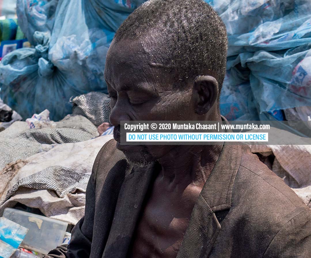 Poor old African man: Didi, 68 years old, is a homeless urban poor who spends his days collecting waste plastics to sell. Accra, Ghana. Copyright © 2020 Muntaka Chasant