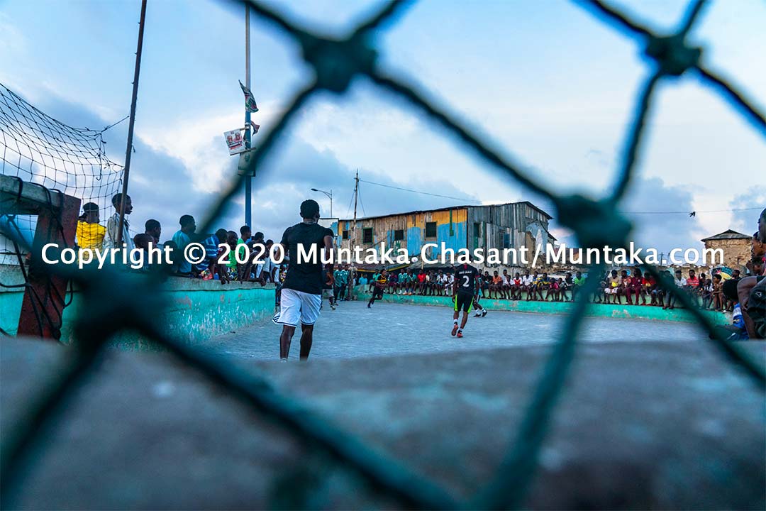 Football in Ghana: Men play street football on concrete at Jamestown, Accra, Ghana. Copyright © 2020 Muntaka Chasant