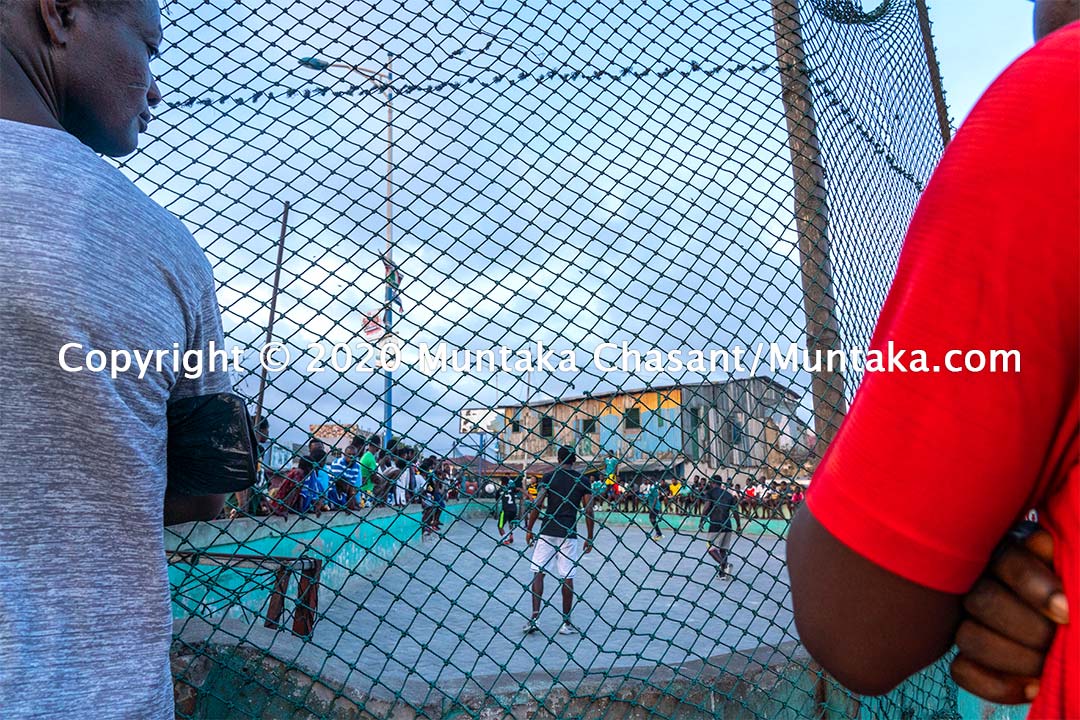 Football in Ghana: Men play football on concrete in Accra, Ghana's capital city. Copyright © 2020 Muntaka Chasant