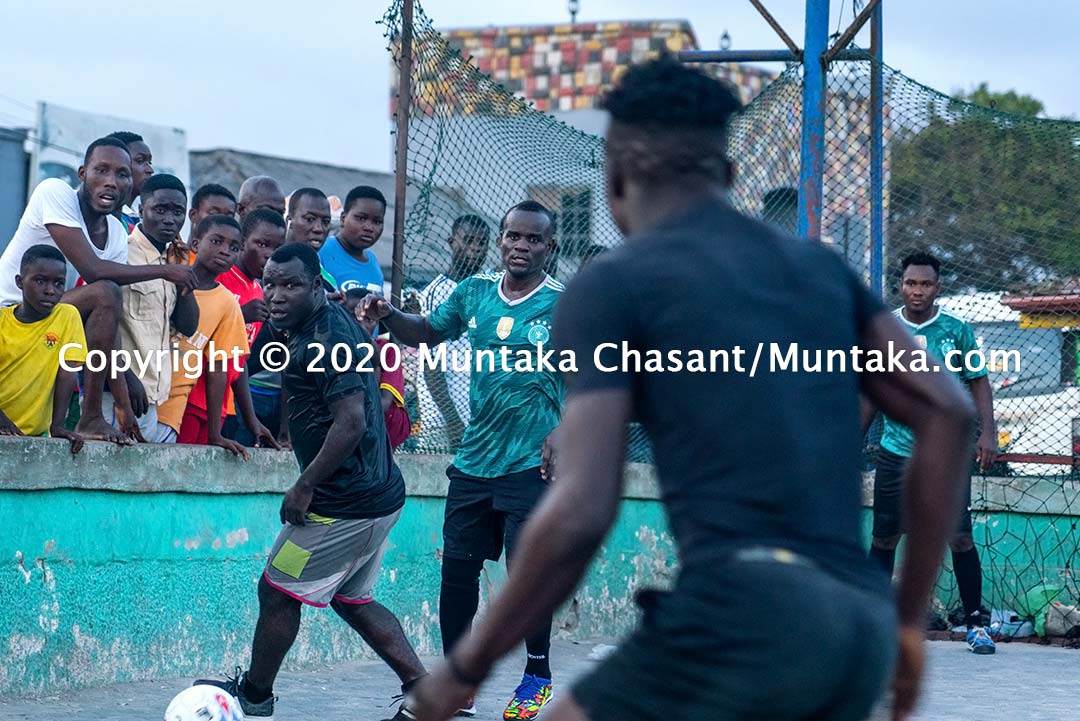 Street soccer image: Joshua Clottey and other Jamestown residents play soccer on the street at Jamestown in Accra, Ghana's capital city. Copyright © 2020 Muntaka Chasant