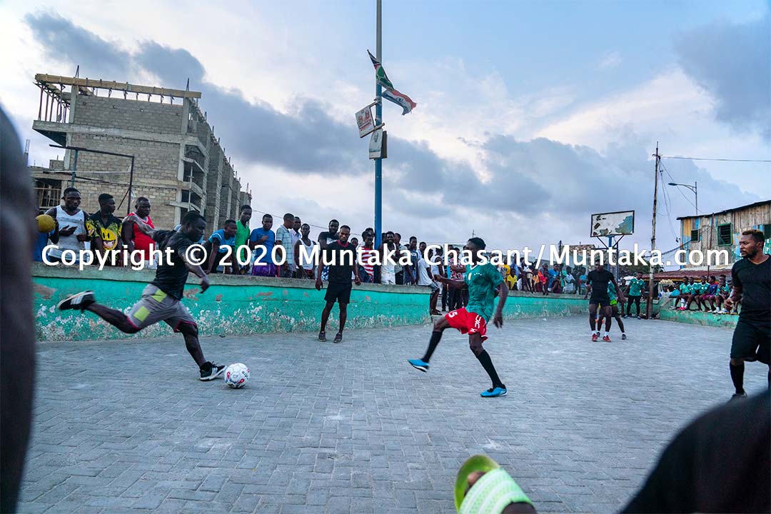 Street football in Ghana: Jamestown residents, including the boxer Joshua Clottey, play football on the street at Jamestown, Accra, Ghana. Copyright © 2020 Muntaka Chasant