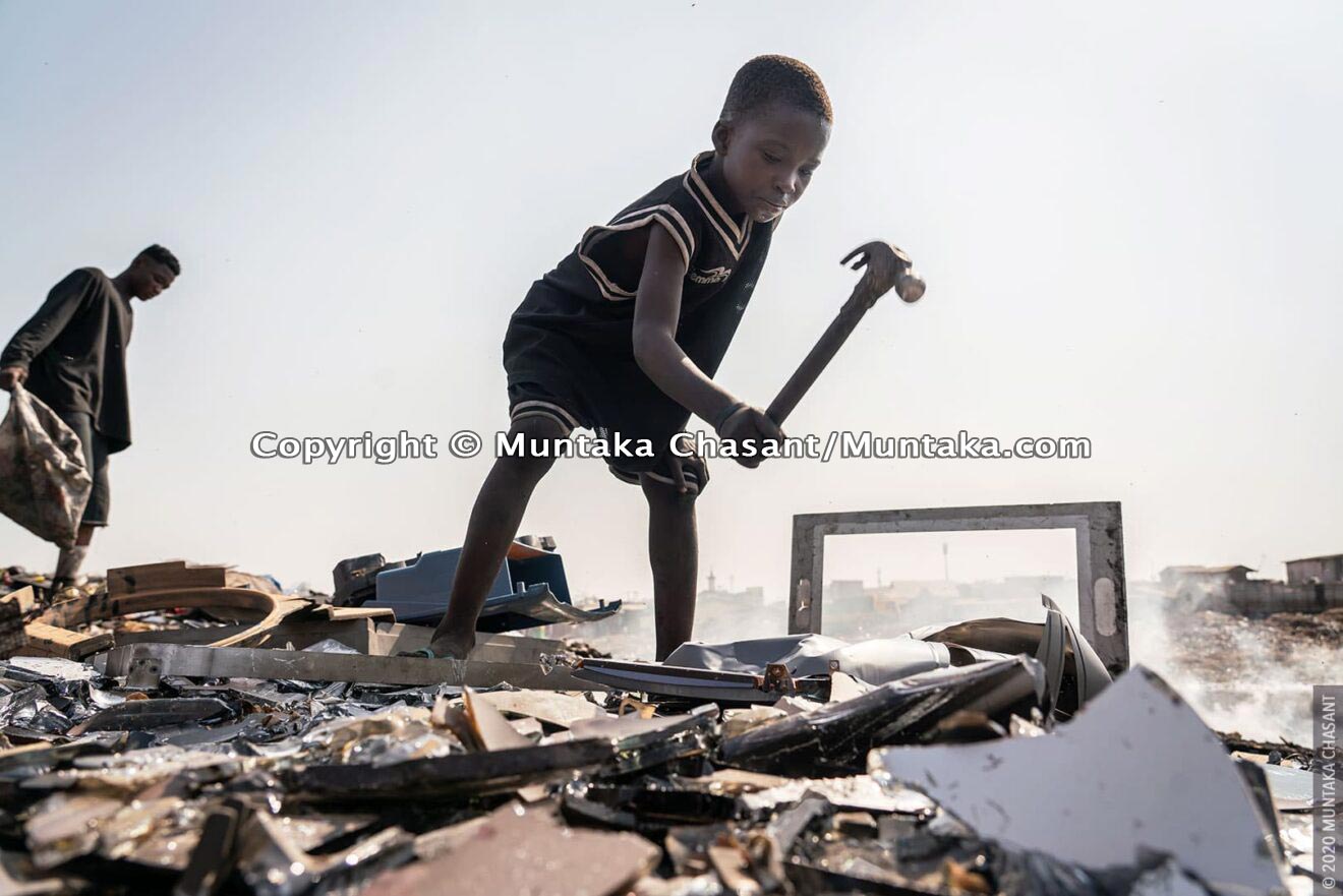 Child labour: 9-year-old Kwadwo is using a hammer to break apart a cathode-ray tube-based TV for the iron materials inside at Agbogbloshie, Ghana. This exposed him to dangerous levels of lead. © 2020 Muntaka Chasant