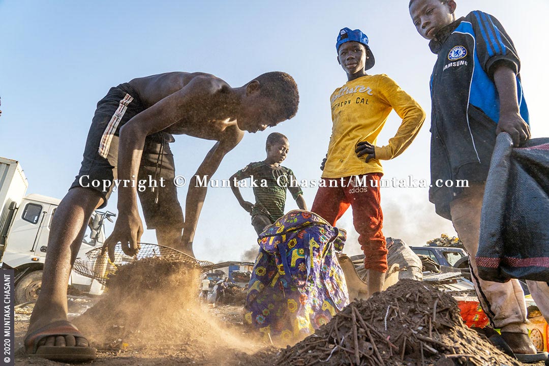 Child labour: A 15 years old boy (Emmanuel Osei) engaged in hazardous work sifts dirt from rusty nails and other small metals before selling them at around $0.15 per kilo at Agbogbloshie, Ghana. An estimated 152 children worldwide between 5 and 17 years are in child labour. 62% of all children in hazardous child labour are boys, according to ILO statistics. Copyright © 2020 Muntaka Chasant
