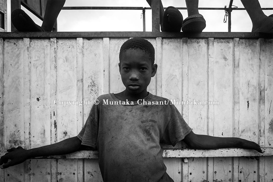 Child Labour: 13-year-old hazardous child labourer leans against a scrapped truck — by the Korle Lagoon. Copyright © Muntaka Chasant