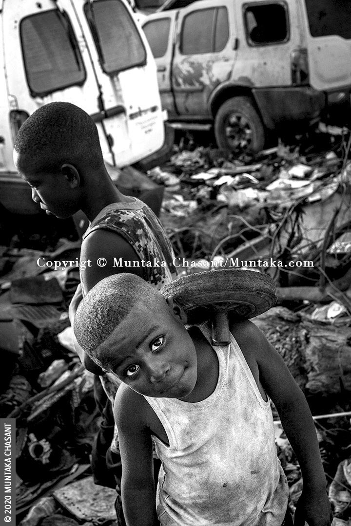 Child Labour: 8-year-old boy engaged in hazardous child labour is have fun on an e-waste dumpsite at Agbogbloshie, Ghana. Around 19 million children below the age of 12 years are in hazardous child labour worldwide, the ILO statistics show. UNICEF estimates that nearly 2 million children in Ghana aged 5-17 years are in child labour. About 385 million children worldwide live in extreme poverty and survive on less than $2 a day, according to UNICEF. © 2020 Muntaka Chasant