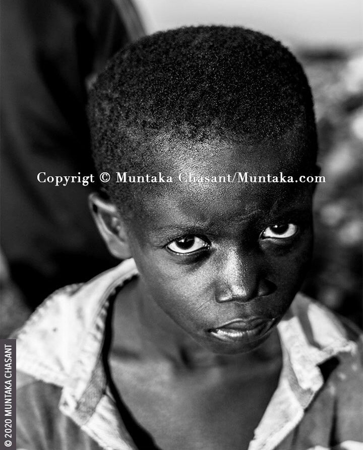 Child Poverty: Engaged in hazardous child labour, 7-year-old boy Kwadwo Michael handpicks scrap metals and discarded e-waste components in the soil at Agbogbloshie, an area renowned for its heavy metals contamination. He is exposed to toxic materials such as lead, mercury, arsenic, cadmium, and chromium from the informal recycling of e-waste around the area. 19 million children below the age of 12 years are in hazardous child labour worldwide, ILO statistics show. © 2020 Muntaka Chasant