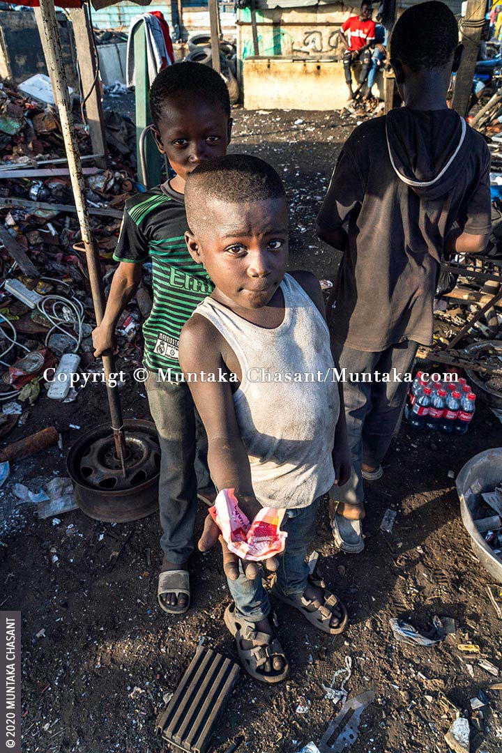 Child Labour: An 8 years old boy engaged in hazardous child labour at Agbogbloshie displays how much he was paid for selling scrap metals at Agbogbloshie, Ghana. 73 million children between 5 and 17 years worldwide are in hazardous child labour, according to the ILO. The minimum age for hazardous work in Ghana is 18, according to Section 91 of the Children’s Act, 1998 (Act 560). © 2020 Muntaka Chasant