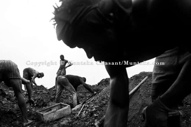 September 14, 2021: Urban poor men search for scrap metal buried deep under the surface of the demolished Agbogbloshie Scrapyard site. Copyright © Muntaka Chasant