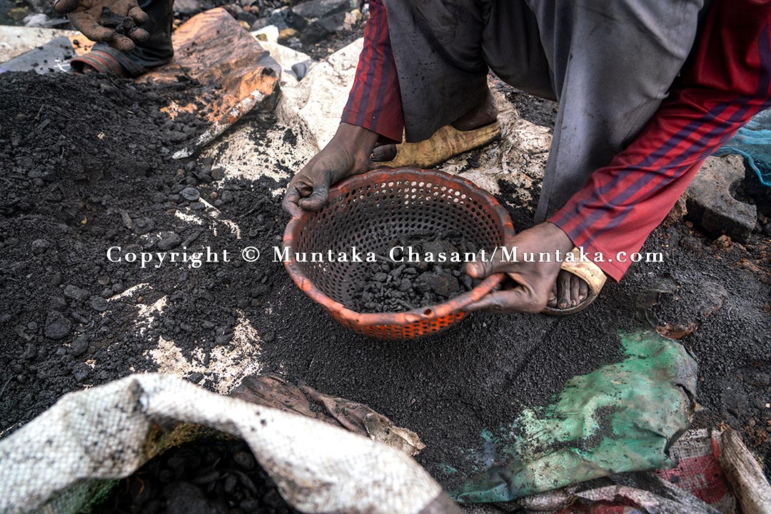 Processing to separate dirt from rusted scrap metal recovered after digging deep into the surface of the demolished Agbogbloshie site. Copyright © Muntaka Chasant