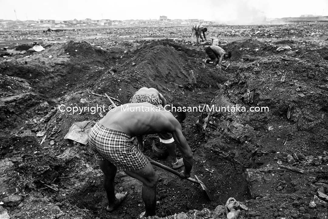 14 September 2021: What looks like artisanal mining trenches are desperate urban poor men digging deep into the surface to prospect for scrap metals 10 weeks after the Agbogbloshiee demolition. The demolished scrapyard was a lifeline for thousands of urban poor. Copyright © Muntaka Chasant
