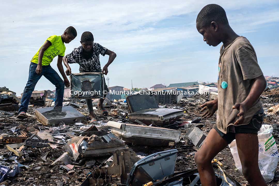 Hazardous child labour in Africa: Left to right: Ankrah, 14, Osei, 15, and Mustafa, 13, are dismantling old CRT TVs with their bare hands and rocks to recover the iron metals inside. This exposed them to heavy metals, including lead and cadmium. Approximately 31.5 million children in Africa are in child labour, the ILO statistics show. © 2020 Muntaka Chasant